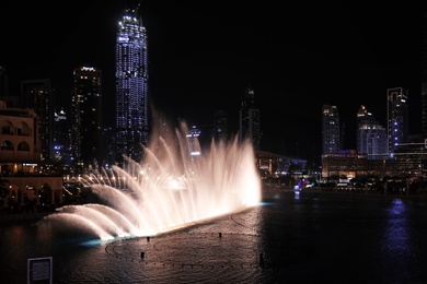 Photo of DUBAI, UNITED ARAB EMIRATES - NOVEMBER 04, 2018: Famous dancing fountain show on Burj Khalifa lake at night