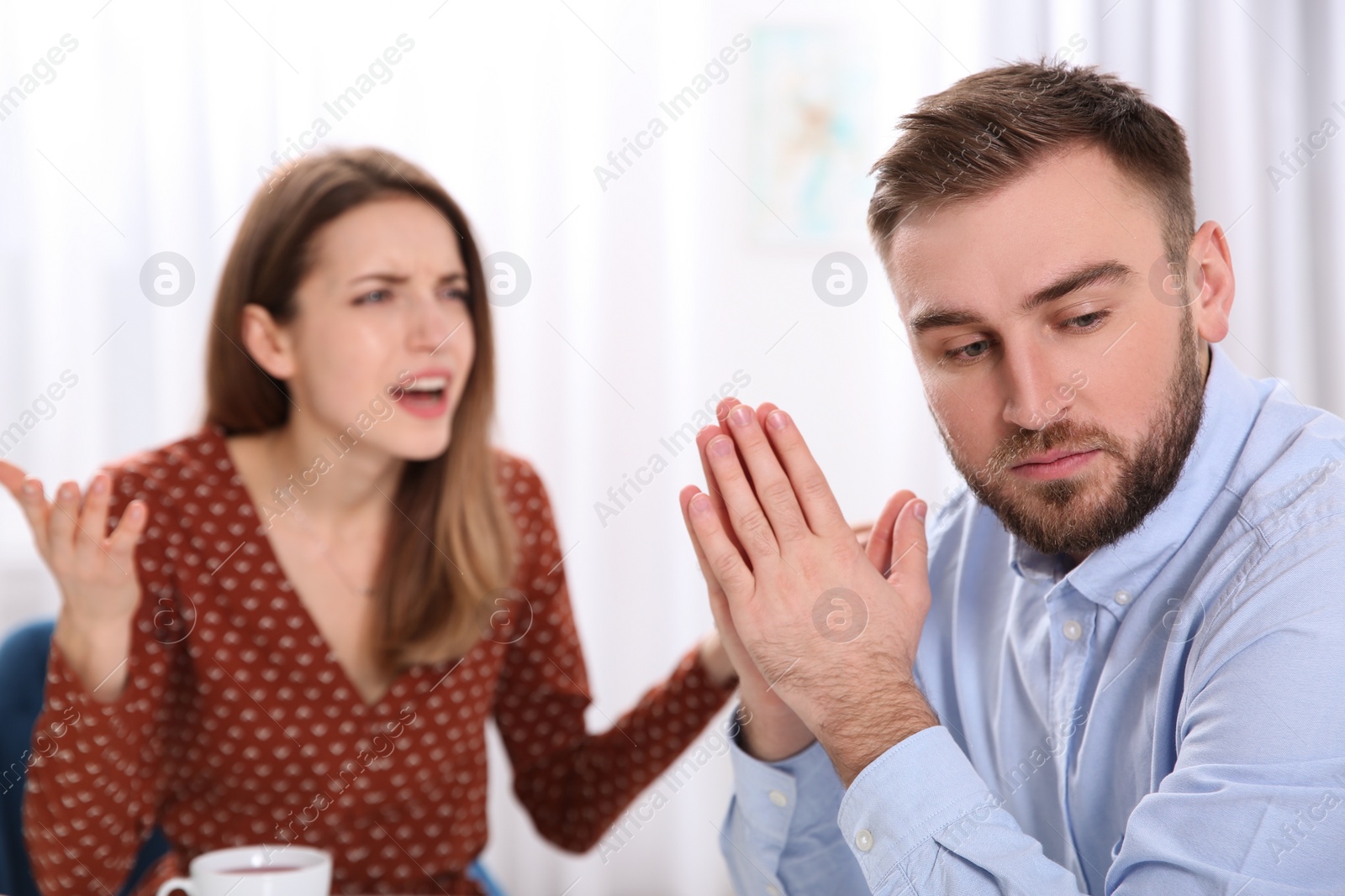 Photo of Couple having quarrel in cafe. Relationship problems