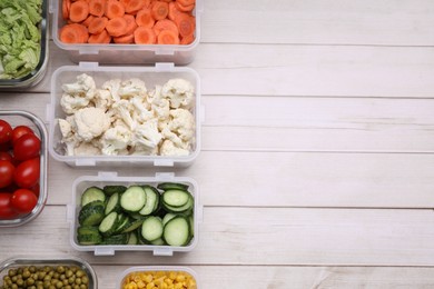 Photo of Plastic and glass containers with different fresh products on white wooden table, flat lay. Space for text
