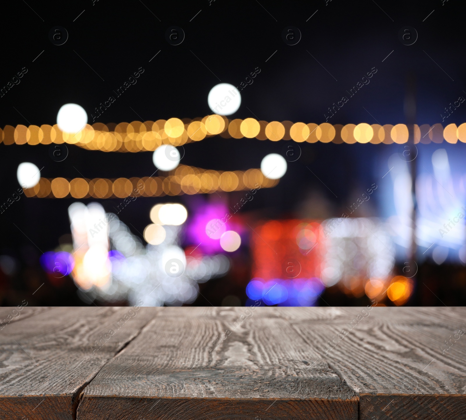 Image of Empty wooden surface against blurred lights. Bokeh effect 
