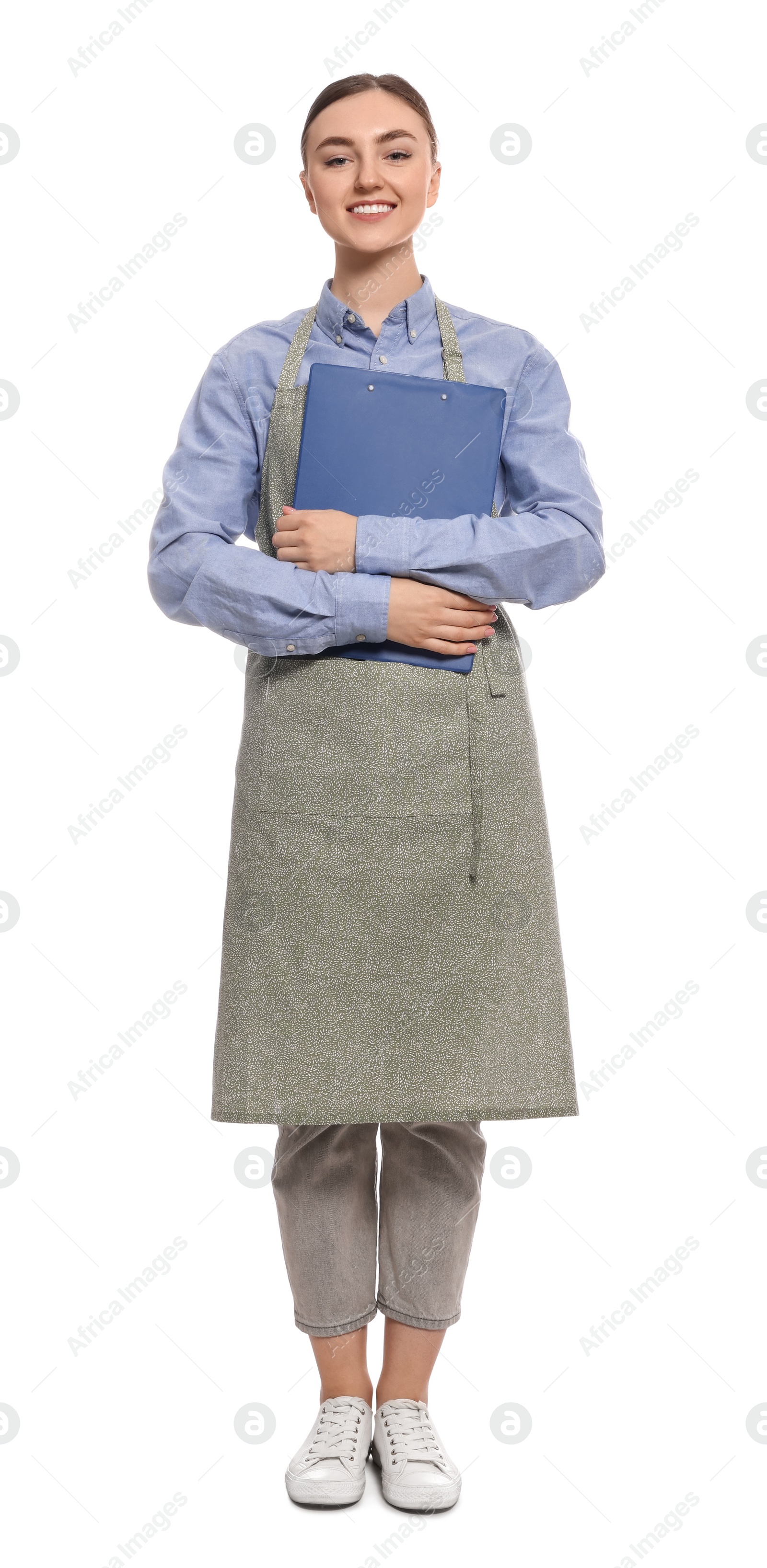 Photo of Beautiful young woman in clean apron with clipboard on white background