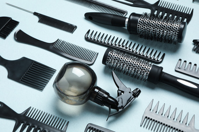 Photo of Composition with modern hair combs and brushes on light background