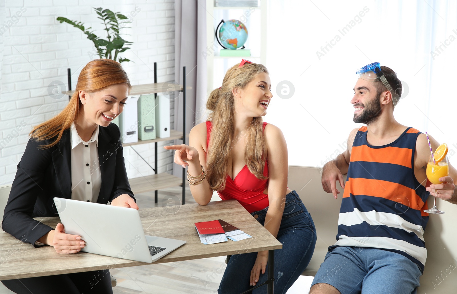 Photo of Beautiful young couple visiting travel agency office