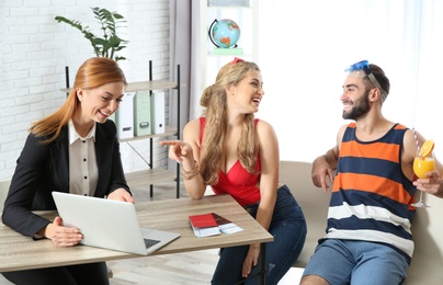 Photo of Beautiful young couple visiting travel agency office