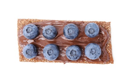 Fresh crunchy rye crispbread with chocolate spread and blueberries isolated on white, top view
