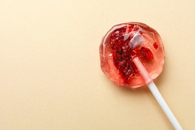 Photo of Sweet colorful lollipop with berries on beige background, top view. Space for text