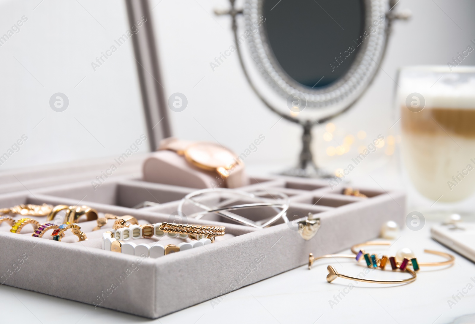 Photo of Elegant jewelry box with beautiful bijouterie on white table, closeup