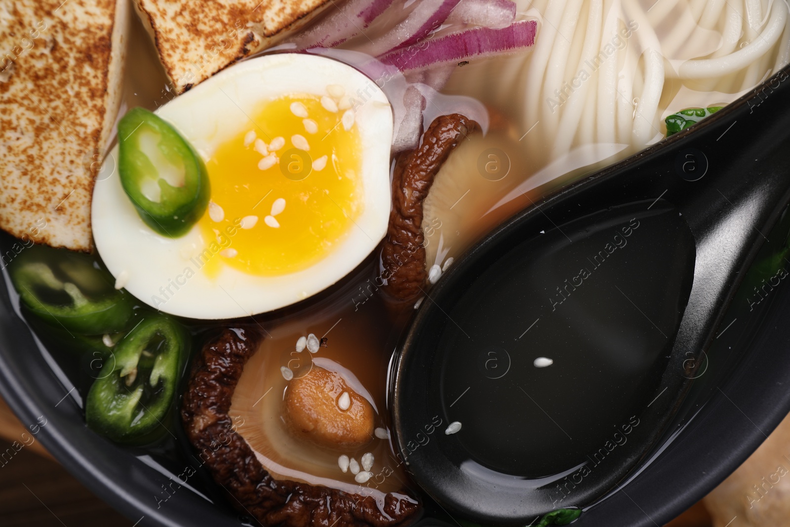 Photo of Delicious vegetarian ramen in bowl, top view