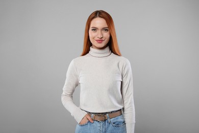 Photo of Portrait of beautiful young woman on light gray background