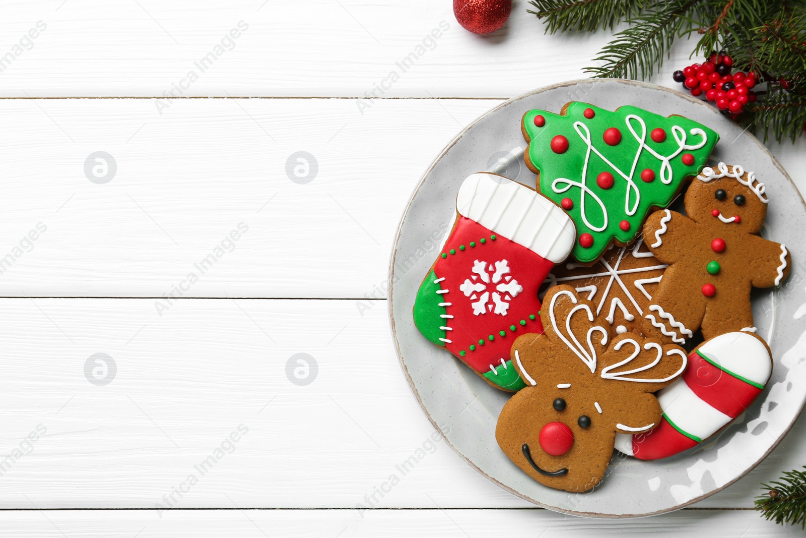 Photo of Tasty homemade Christmas cookies on white wooden table, top view. Space for text