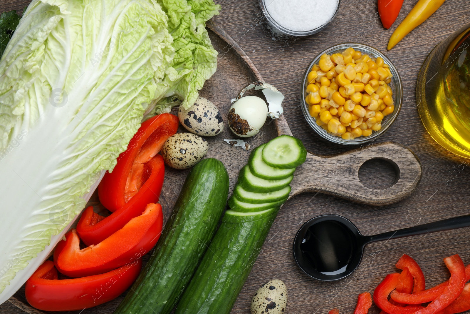 Photo of Chinese cabbage and different products on wooden table, flat lay