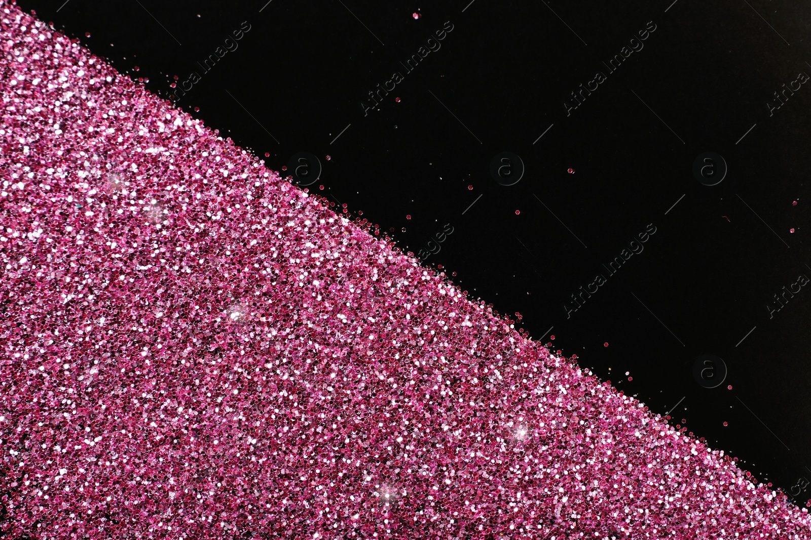 Photo of Rose gold glitter on black background, top view with space for text