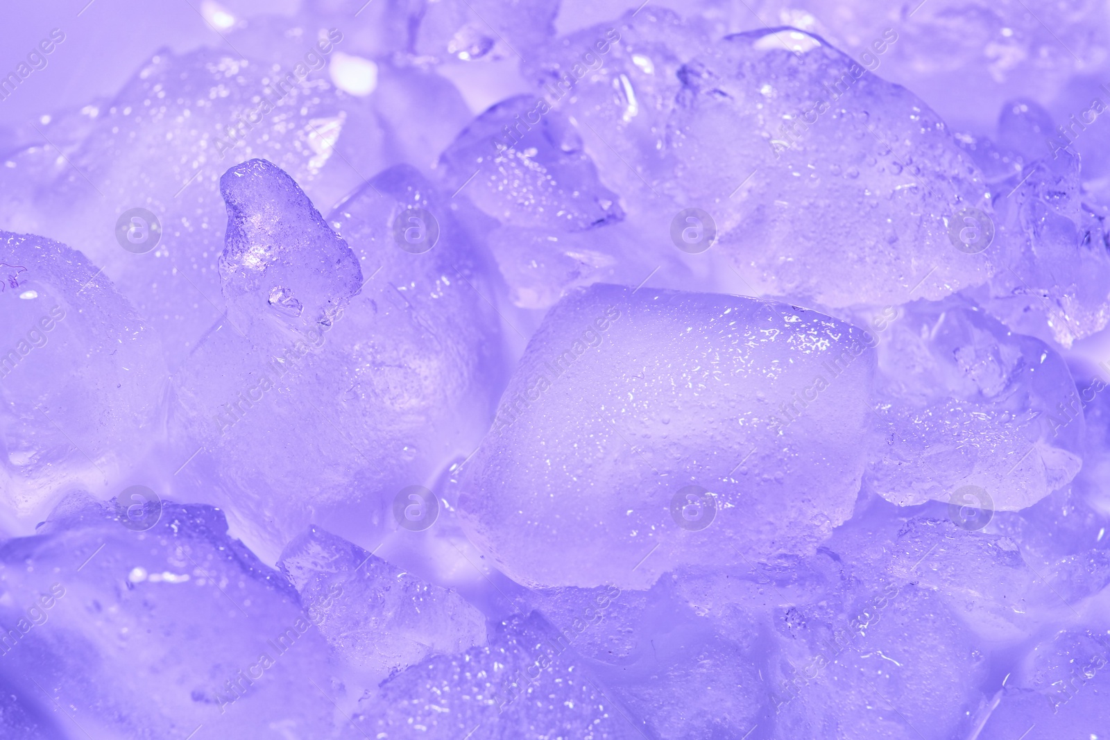 Photo of Many melting ice cubes on color background