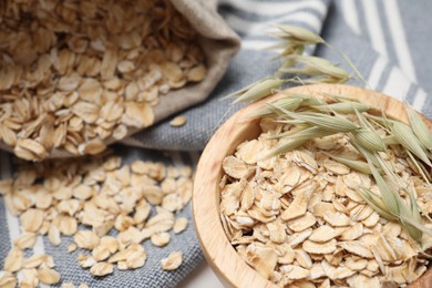 Bowl with oatmeal and florets on table, closeup. Space for text