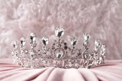 Beautiful silver tiara with diamonds on pink cloth
