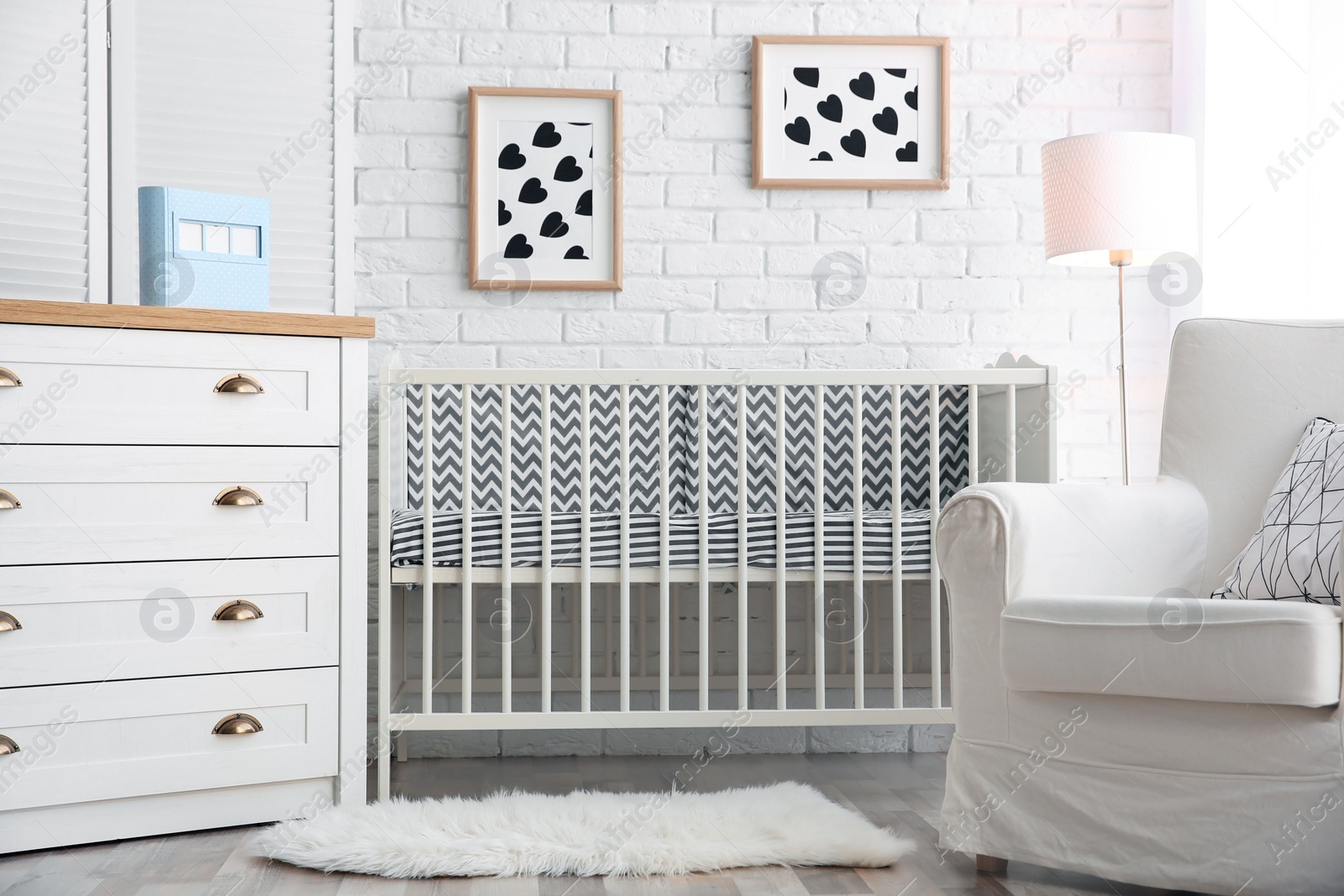 Photo of Modern interior of light cozy baby room with crib