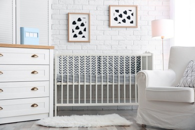 Photo of Modern interior of light cozy baby room with crib