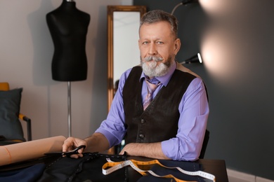 Portrait of mature tailor in atelier