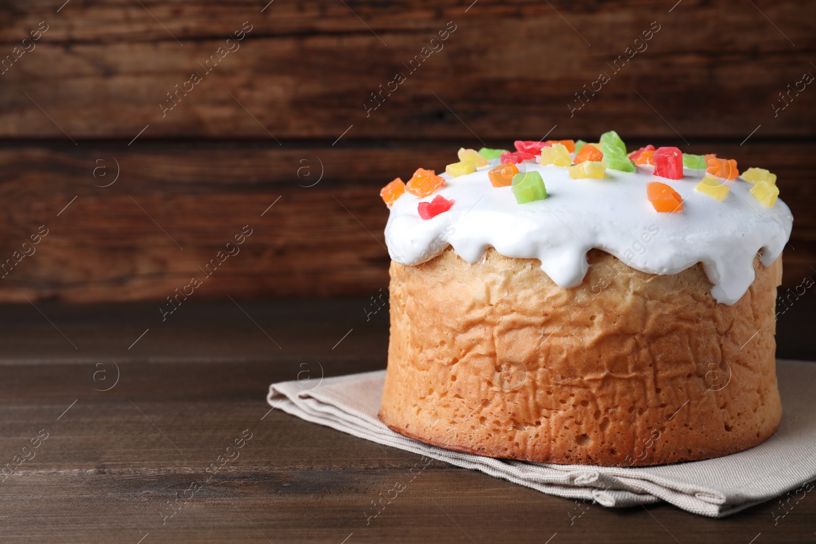 Photo of Traditional decorated Easter cake on wooden table. Space for text