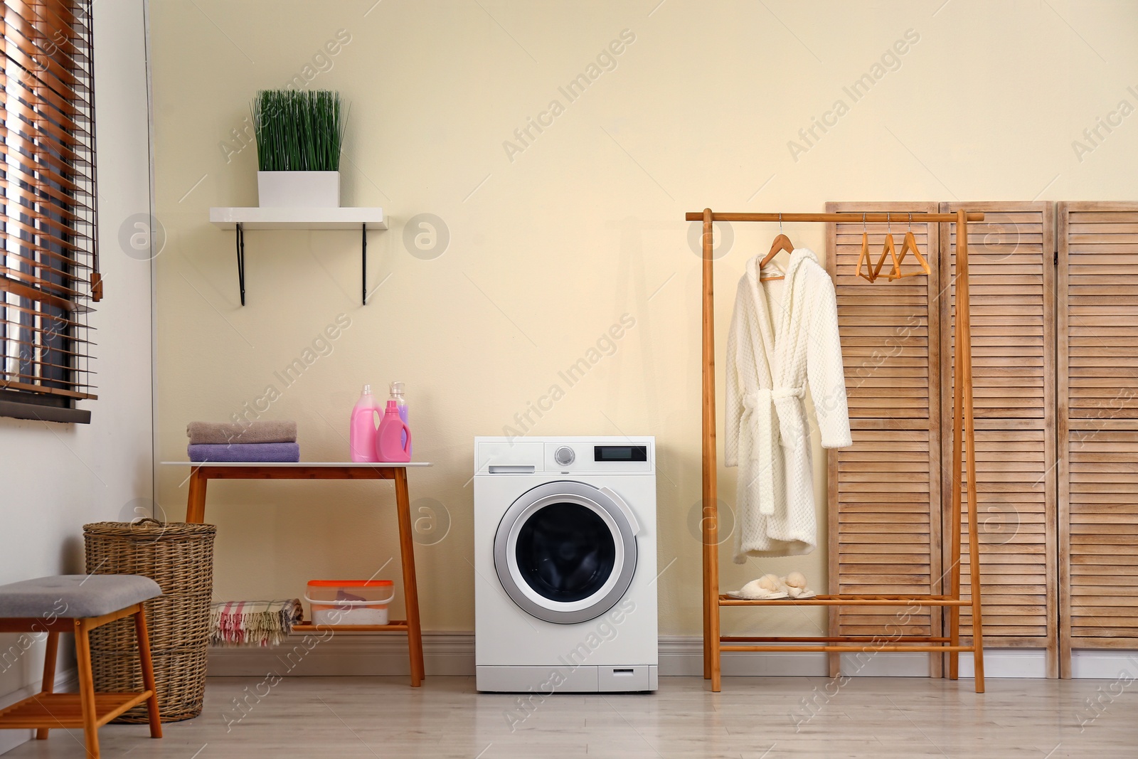 Photo of Laundry room interior with modern washing machine