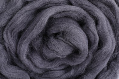 Grey felting wool as background, closeup view