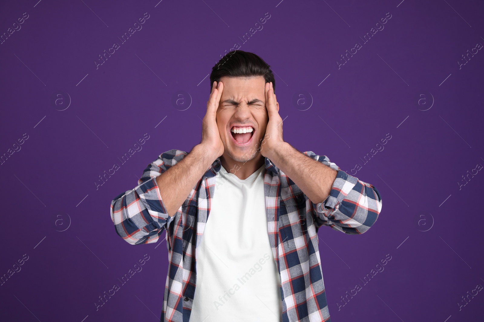 Photo of Portrait of stressed man on purple background