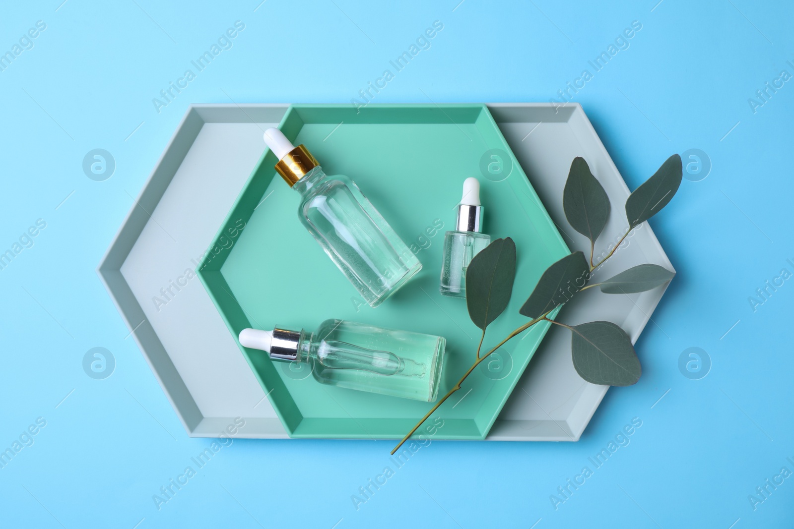 Photo of Flat lay composition with bottles of perfume on color background
