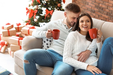 Happy young couple celebrating Christmas at home