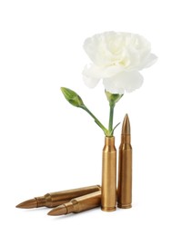 Photo of Bullets and cartridge case with beautiful flower isolated on white