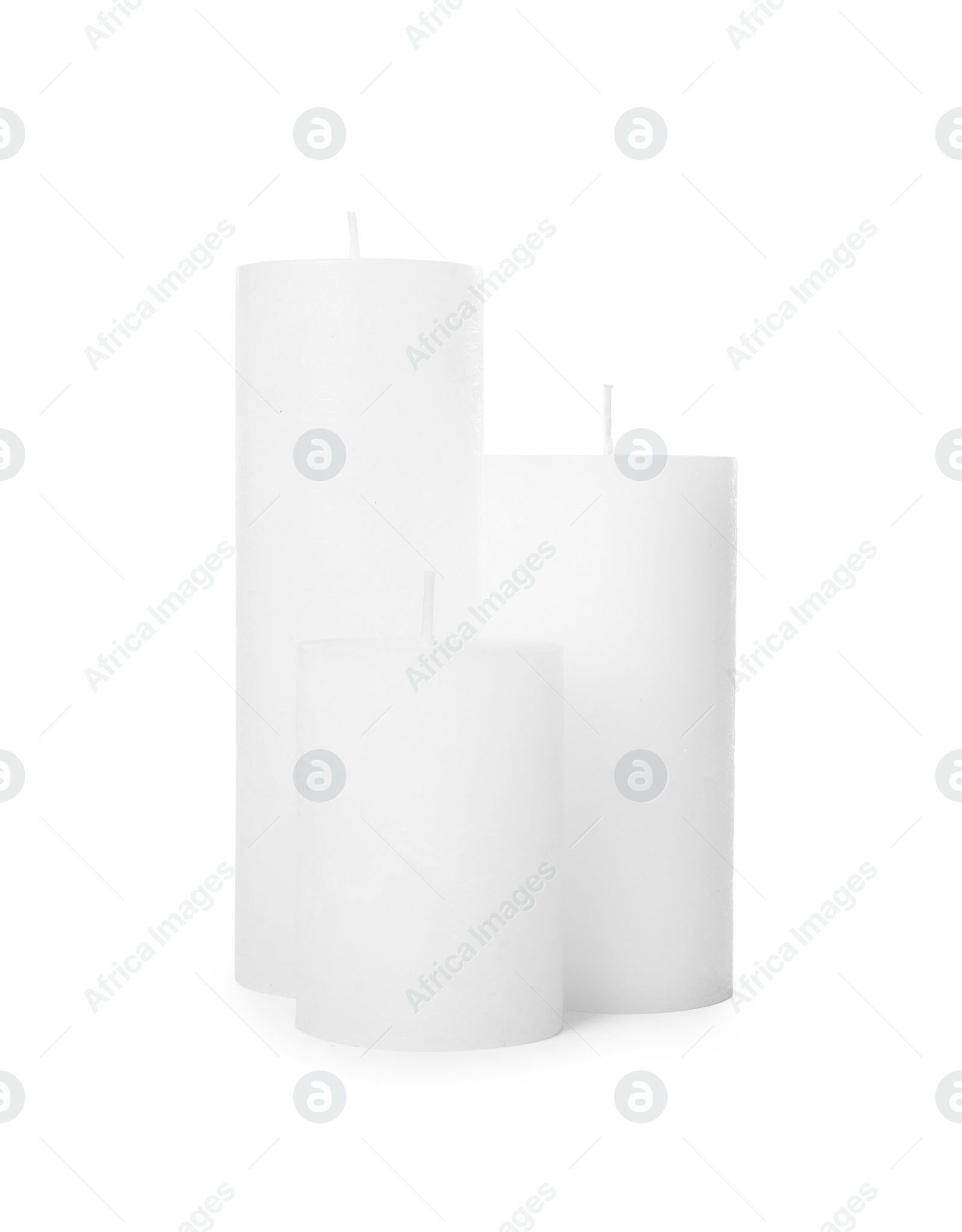 Photo of Three scented wax candles on white background