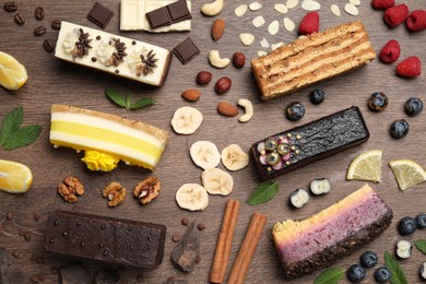 Photo of Flat lay composition with different tasty cakes on wooden table