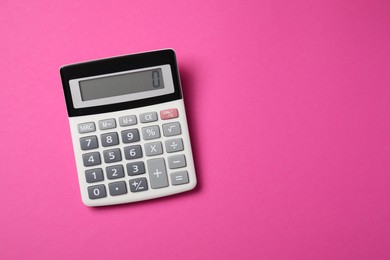 Calculator on pink background, top view. Space for text