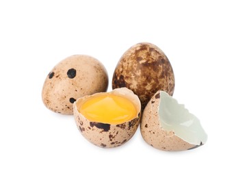 Photo of Whole and cracked quail eggs on white background