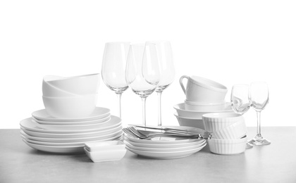 Photo of Set of clean dishes on white background