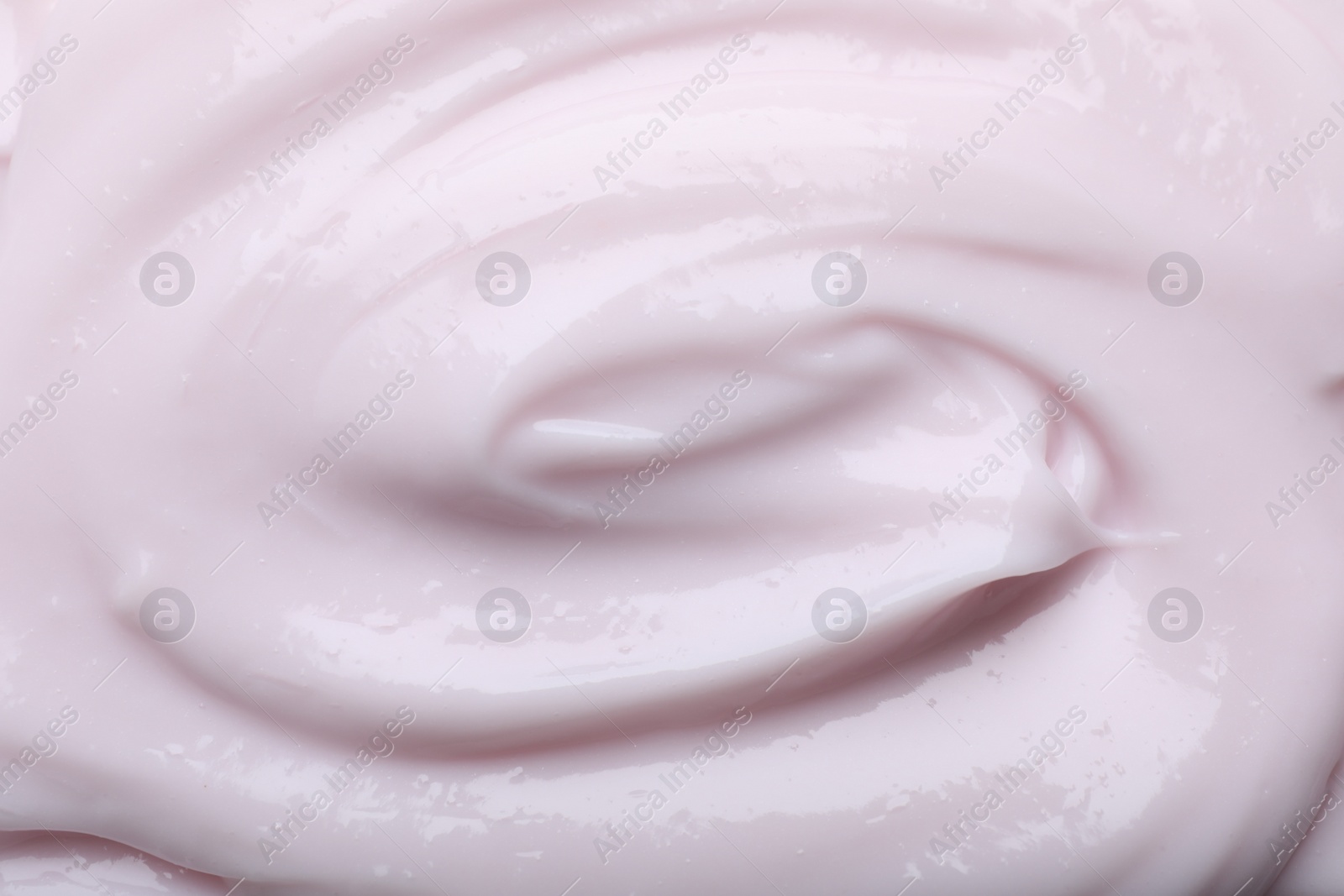 Photo of Closeup view of light pink body cream as background