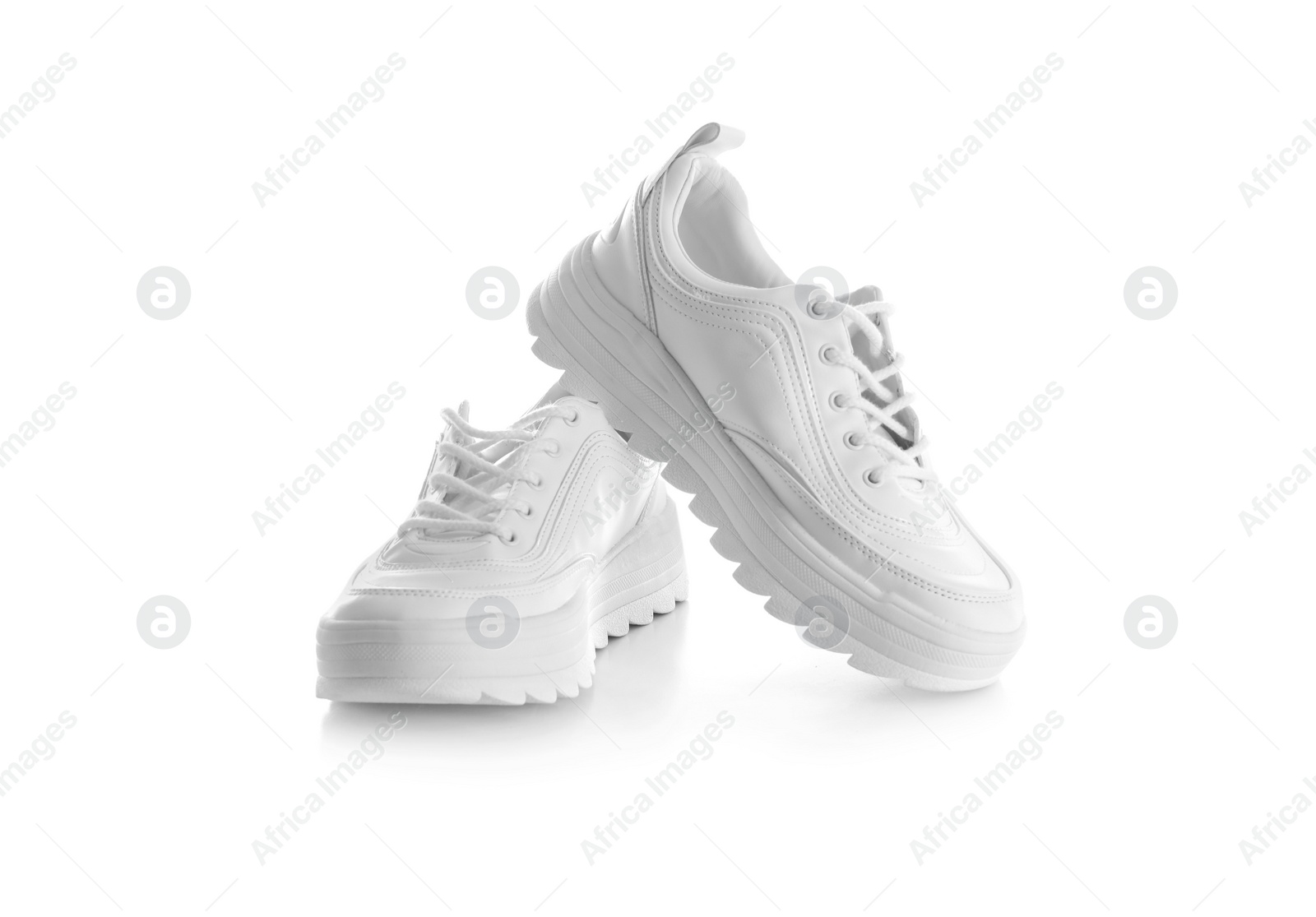 Photo of New stylish sneakers on white background. Trendy footwear