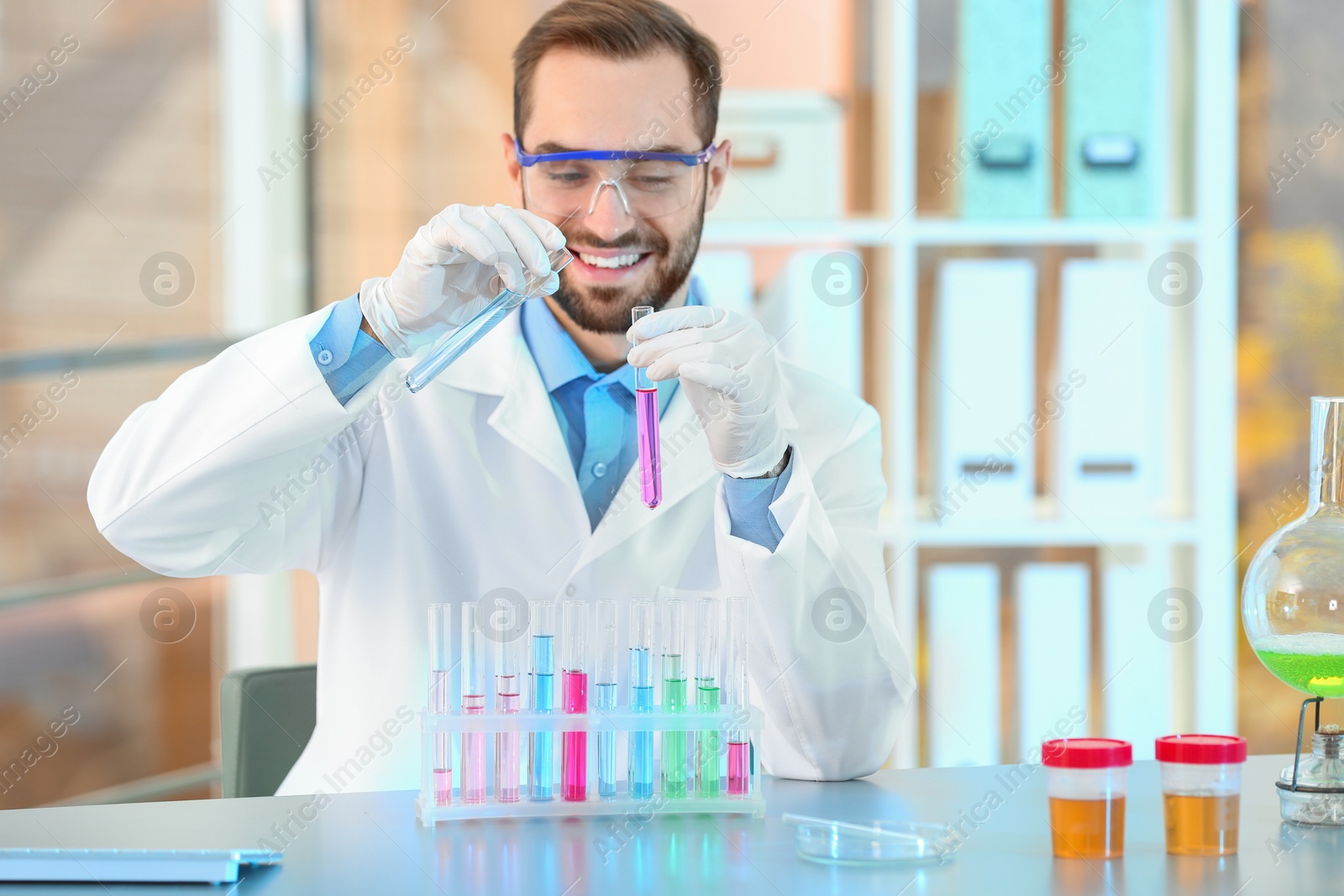 Photo of Young scientist working with test tubes in laboratory. Chemical analysis