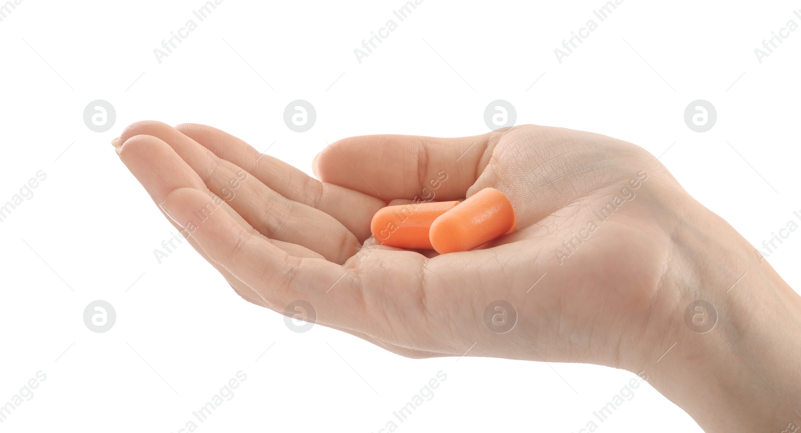 Photo of Woman holding pair of orange ear plugs on white background, closeup