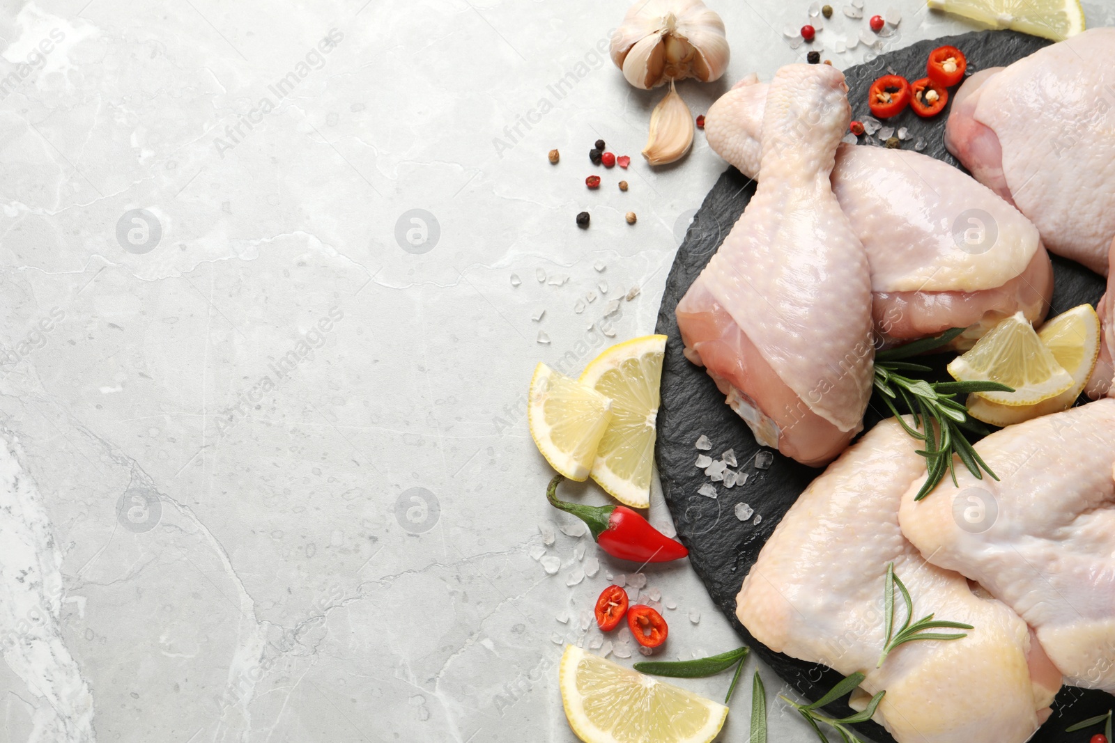 Photo of Flat lay composition with fresh raw chicken meat on light grey table. Space for text