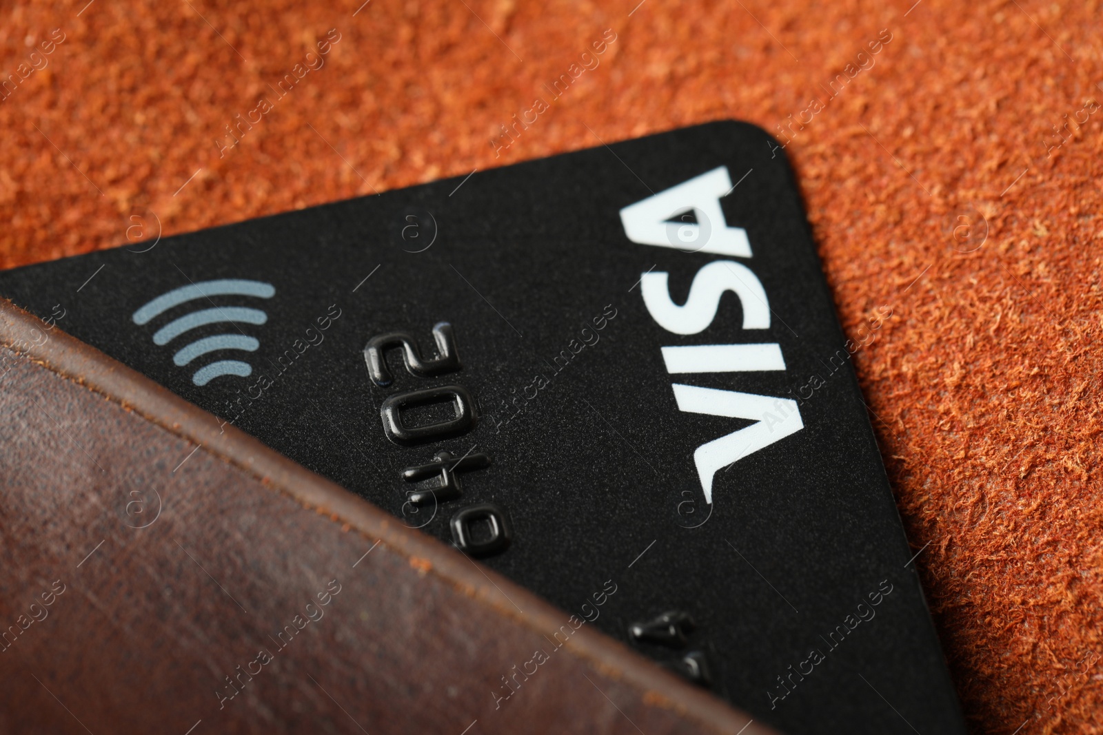 Photo of MYKOLAIV, UKRAINE - FEBRUARY 23, 2022: Bank card of Visa payment system in leather wallet, closeup