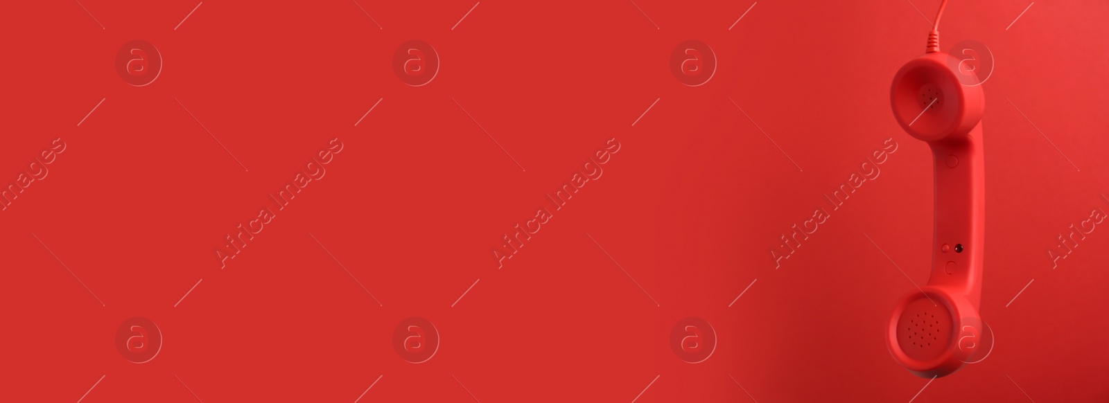Image of Hotline service. Telephone receiver and space for text on red background, banner design