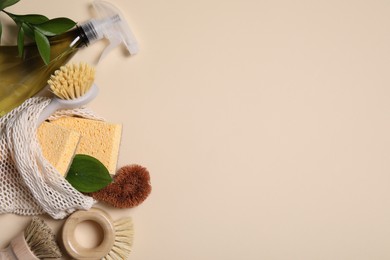 Flat lay composition with different cleaning supplies on beige background. Space for text