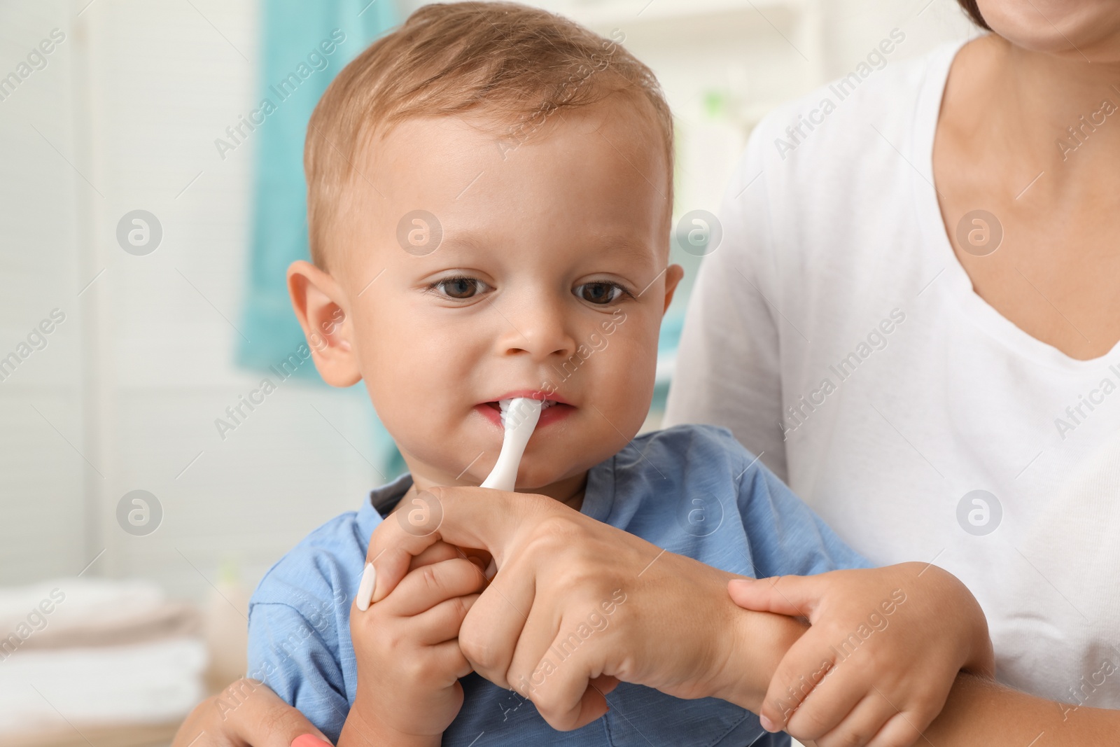 Photo of Woman and her son with toothbrush on blurred background