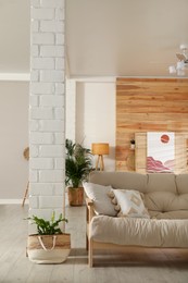 Photo of Light room interior with stylish wooden sofa. Idea for design