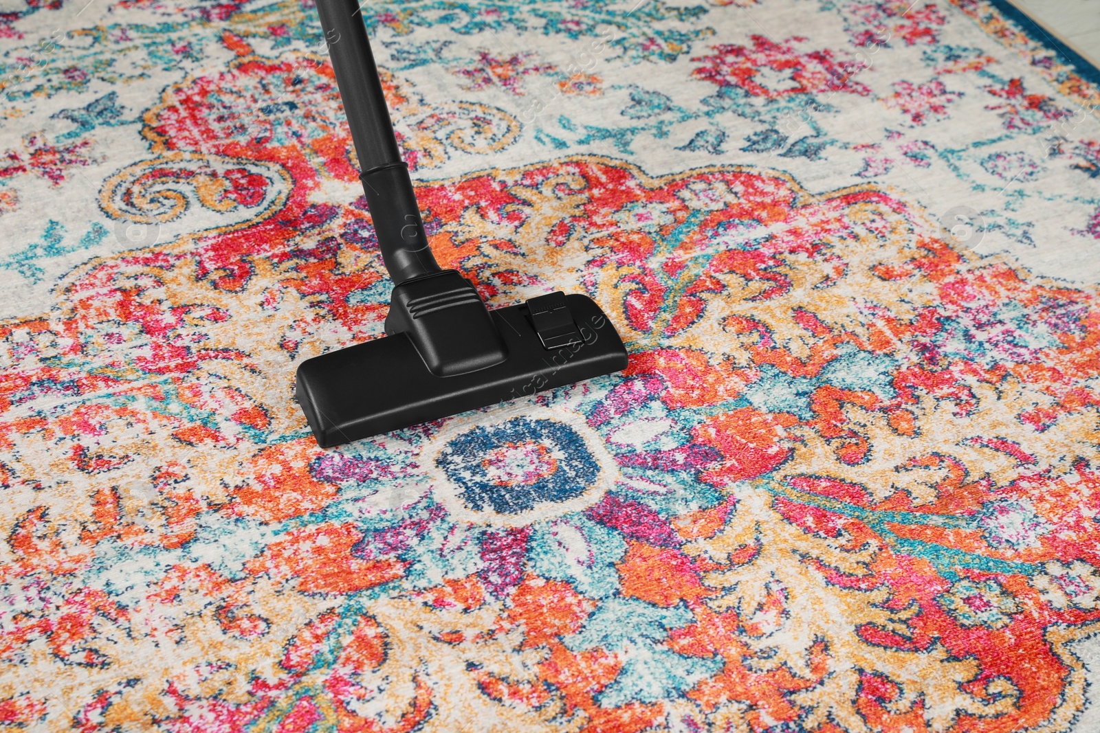 Photo of Removing dirt from carpet with modern vacuum cleaner. Space for text