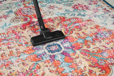 Photo of Removing dirt from carpet with modern vacuum cleaner. Space for text