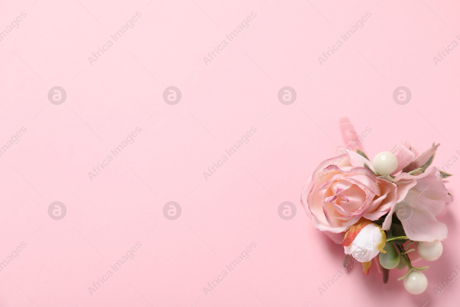 Photo of Stylish boutonniere on pink background, top view. Space for text