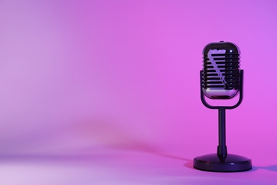 Photo of Retro microphone on color background. Space for text