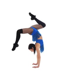 Photo of Beautiful cheerleader in costume doing handstand on white background