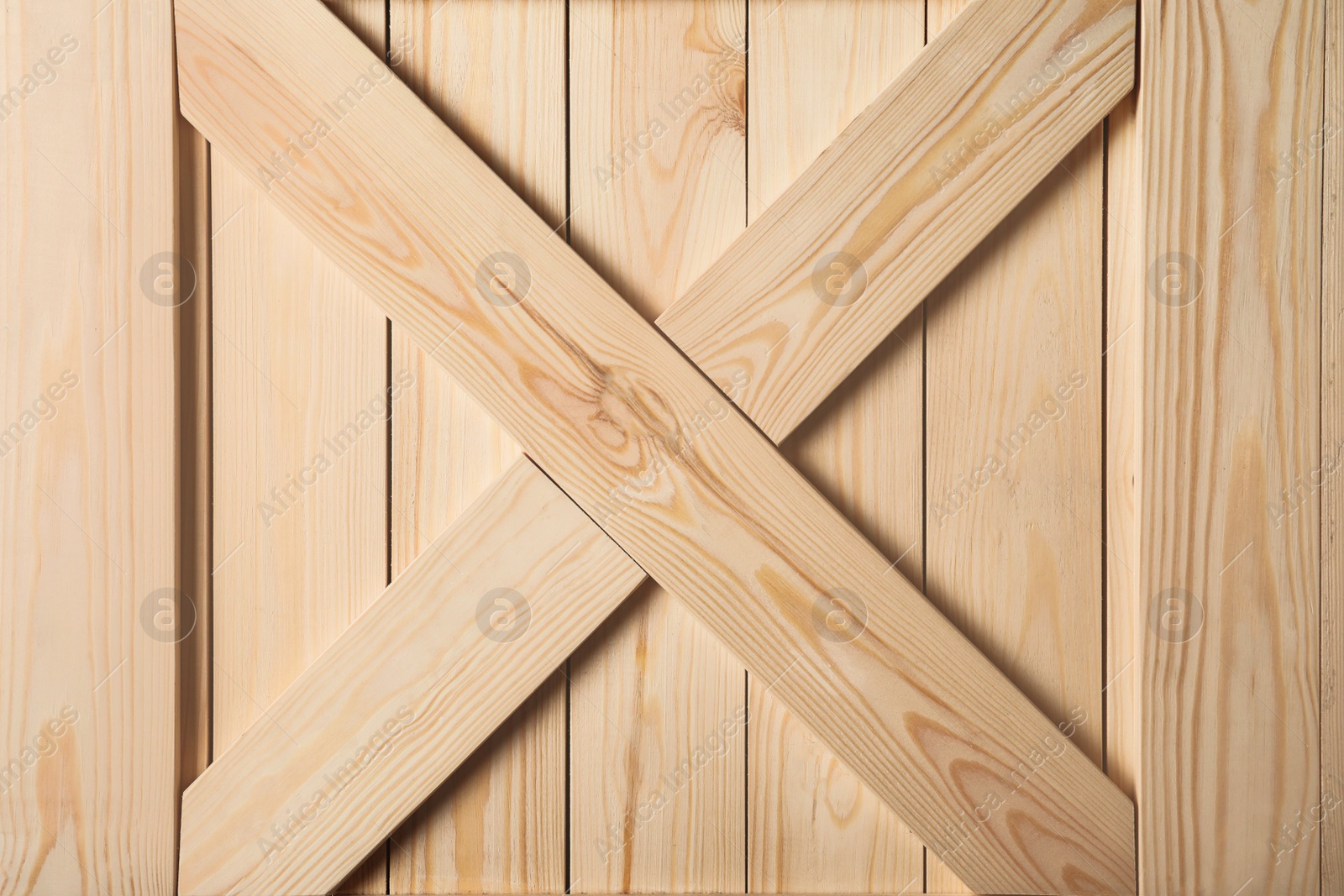 Photo of Wooden crate with crossed planks as background, closeup